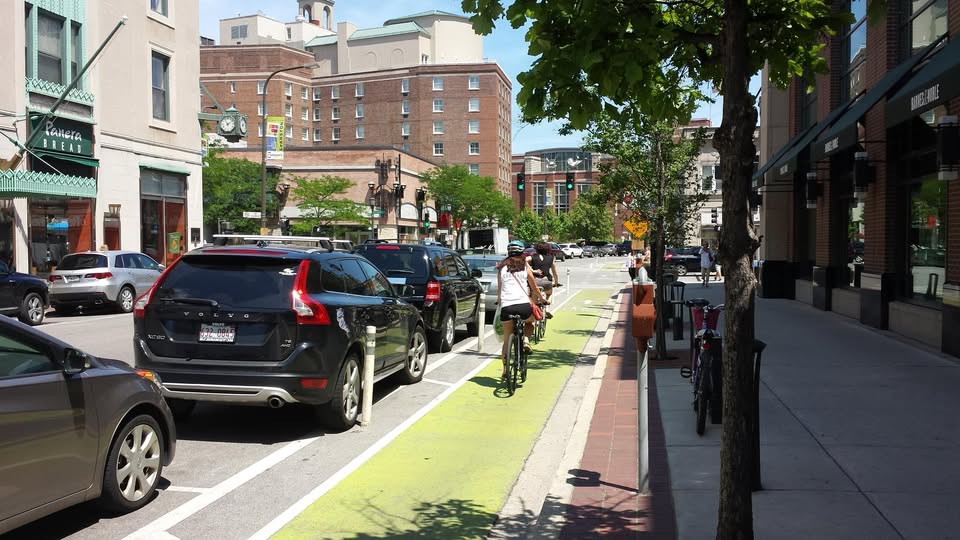 A person riding a bicycling in the bike lane in downtown evanston.